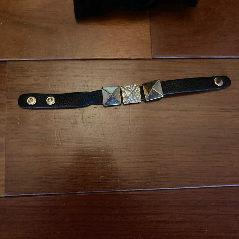 Jewelmint black leather bracelet with gold beads.